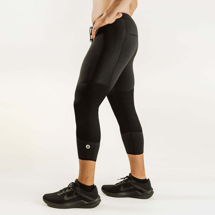 Black 7/8 thermal base layer leggings with contoured knee panels and mid-calf hem