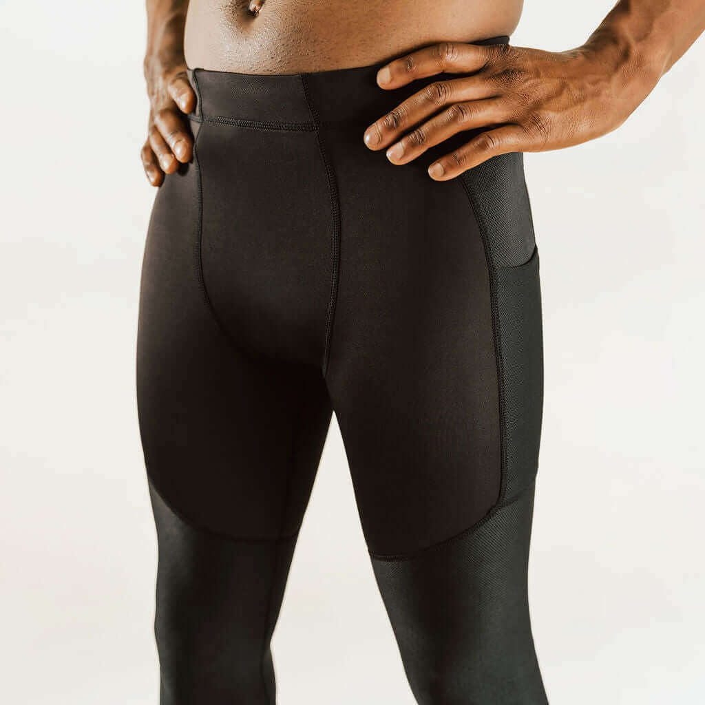 Men's knee support compression pants, front view upper leg, black with contoured support