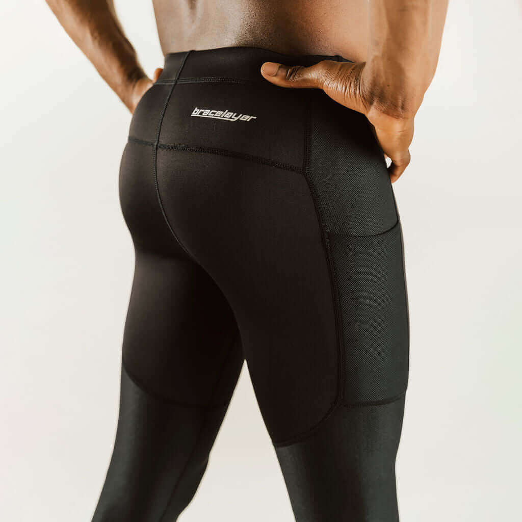 Men's knee support compression pants, back view, black with vented-seam panels and logo