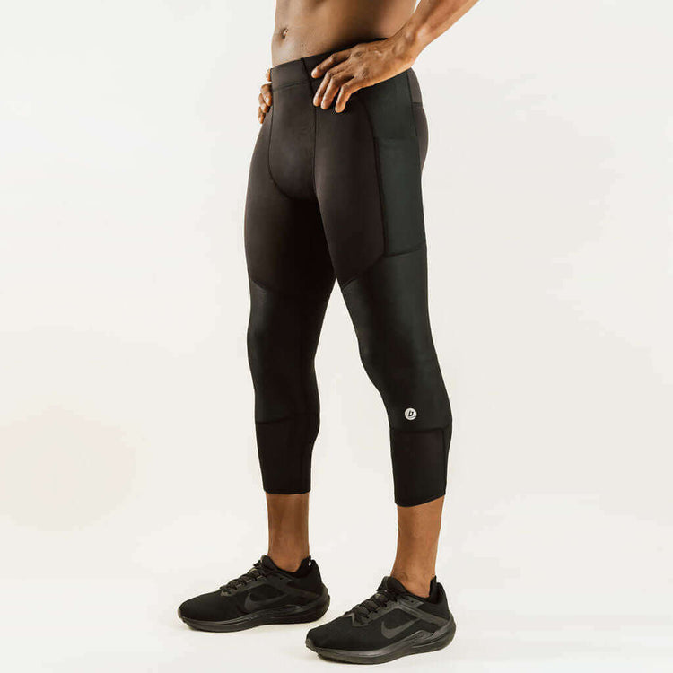 Men's knee support compression pants, 7/8 length, black, side view with reinforced knee