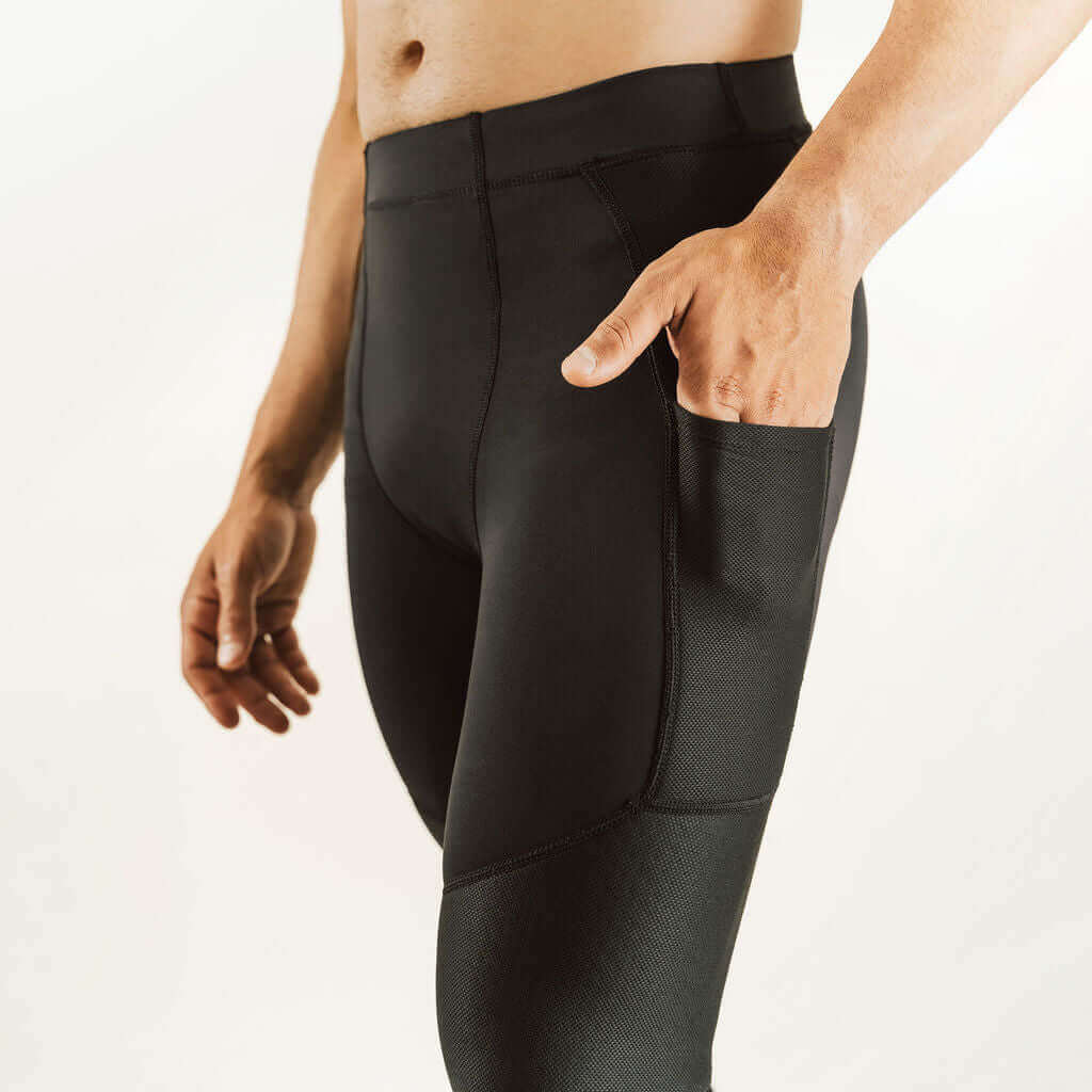Men's knee support compression pants in dark color with side knee reinforcement