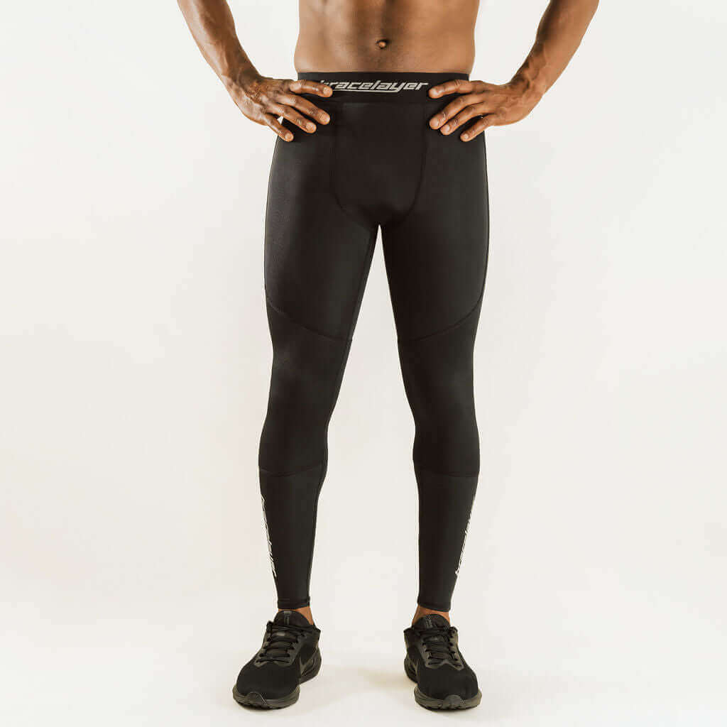 Black knee support compression pants with logo waistband and contoured thighs and knees.