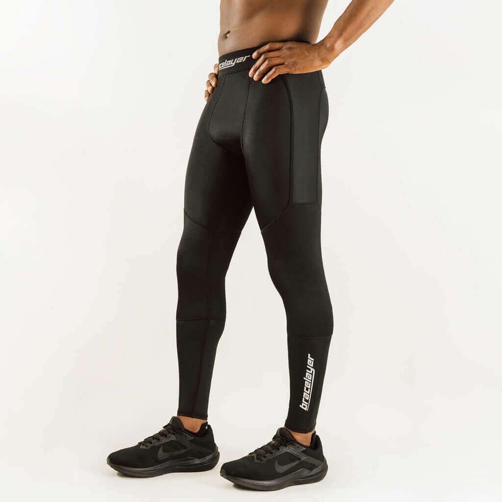 Black compression pants back view with knee panels, vertical seams, and calf logo.