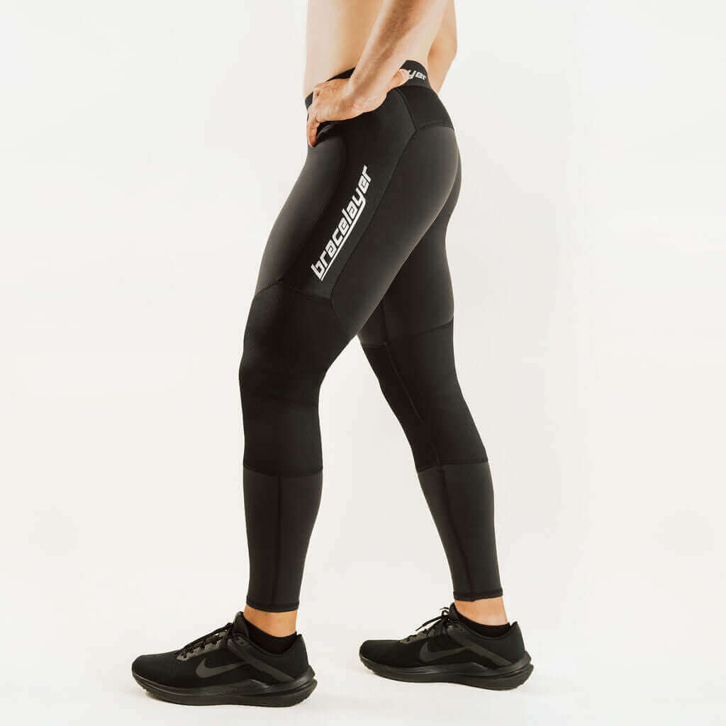 Black knee-support thermal base layer leggings with contoured shin panel.