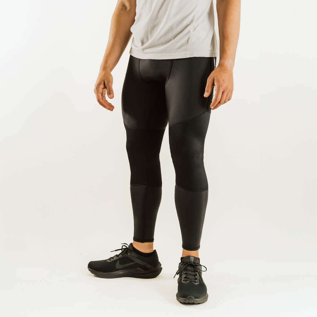 Black thermal base layer leggings with knee support panels, full-length fit.