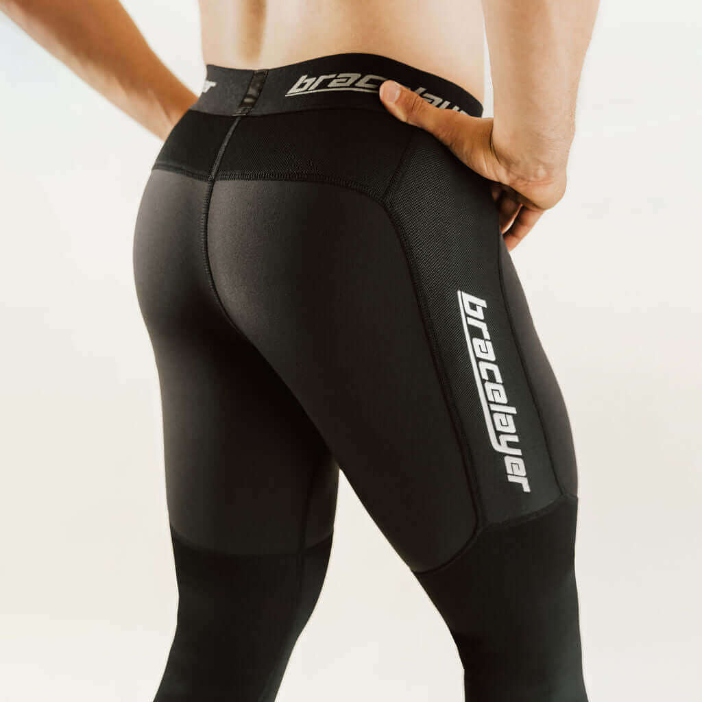 Black thermal base layer leggings with knee support panel and side logo print.