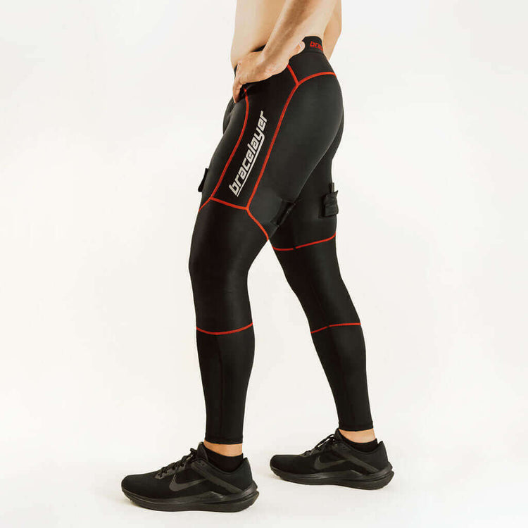 Black hockey compression pants with red piping and padded knee support, angled side view