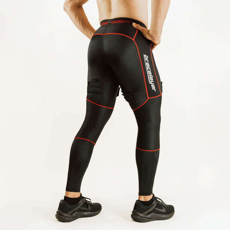 Black hockey compression pants with red piping and knee support pads, back side view
