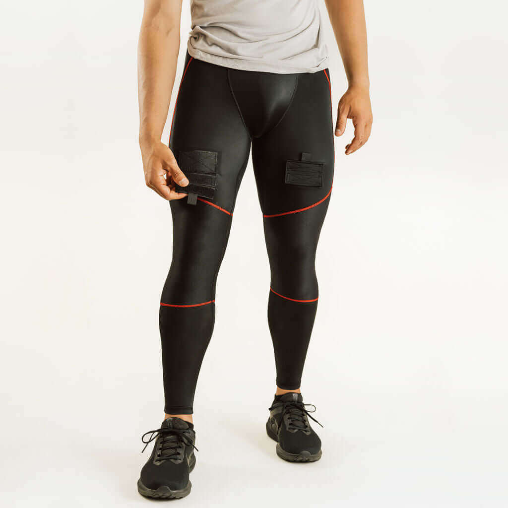 Black hockey compression pants with red piping and padded knee panels, full body view