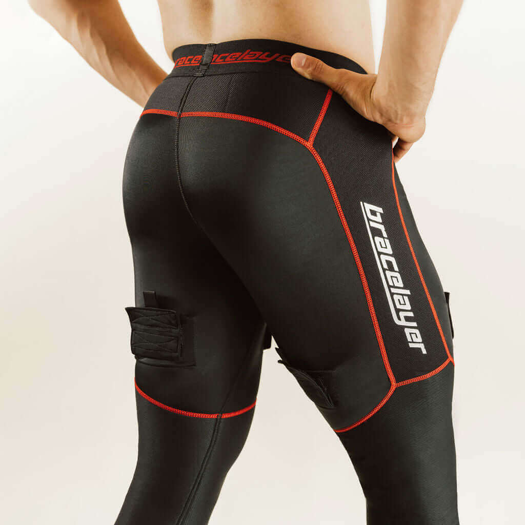 Black hockey compression pants with red piping and padded knee support, back view