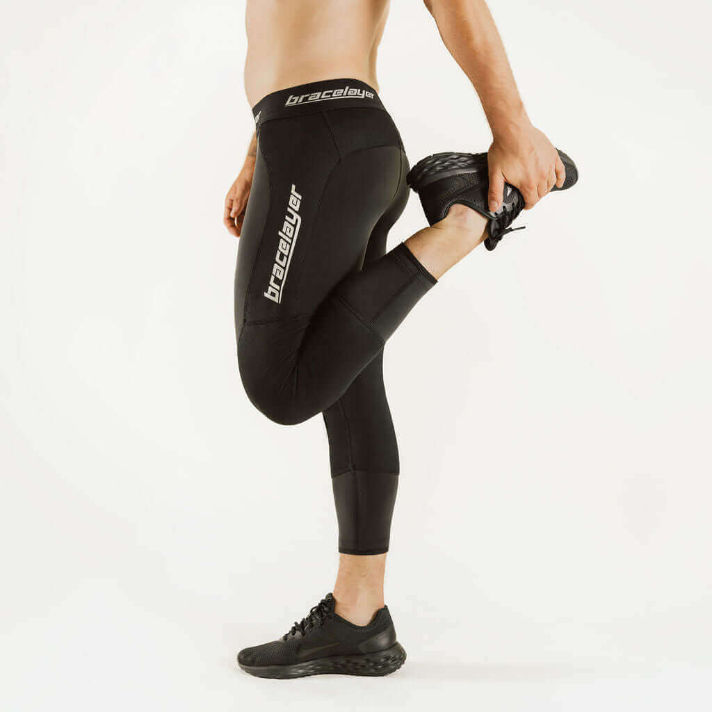 Black boot-cut thermal leggings with knee-support panel and large thigh logo