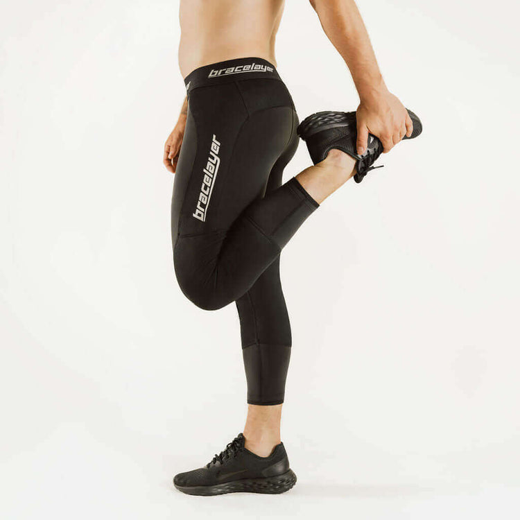 Black boot-cut thermal leggings with knee-support panel and large thigh logo