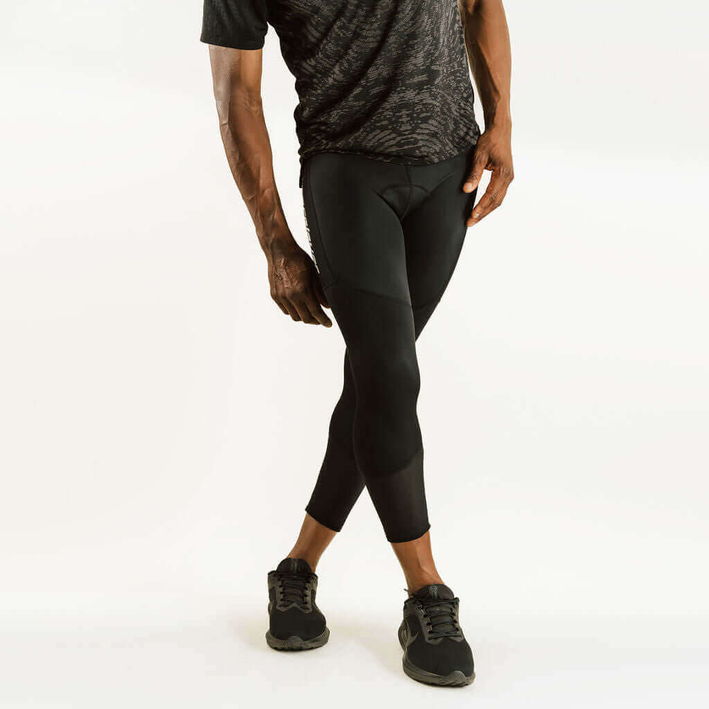 7/8 cycling compression pants with knee support, black side view with curved panels