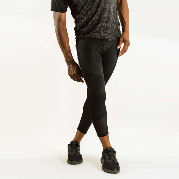 7/8 cycling compression pants with knee support, black side view with curved panels