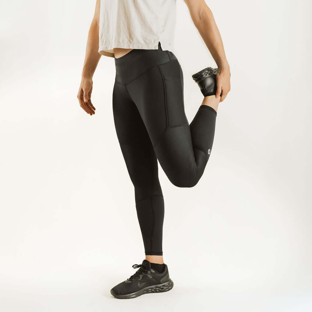 Black knee support compression leggings with contoured panels and tapered ankle cuffs.
