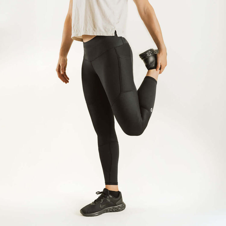 Black knee support compression leggings with contoured panels and tapered ankle cuffs.
