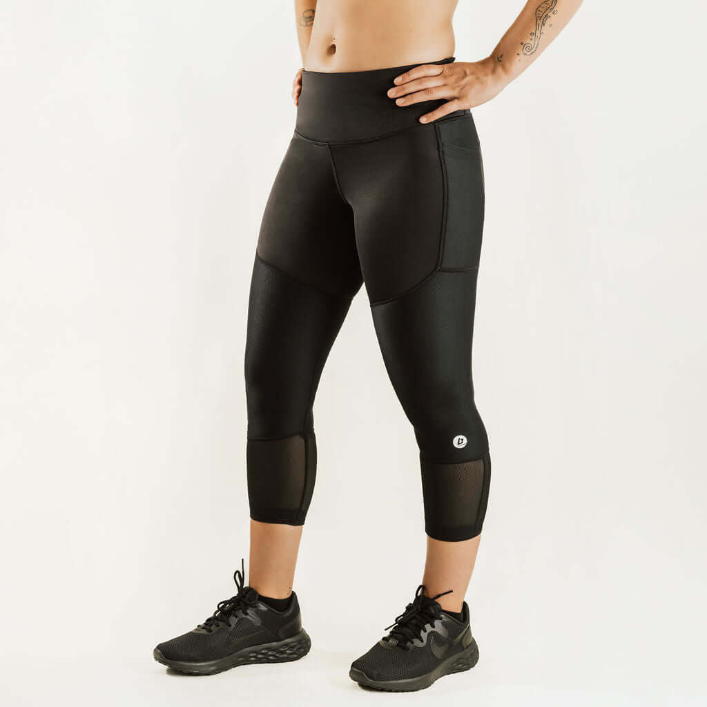 Black 7/8 knee support compression pants with circular knee logo patch