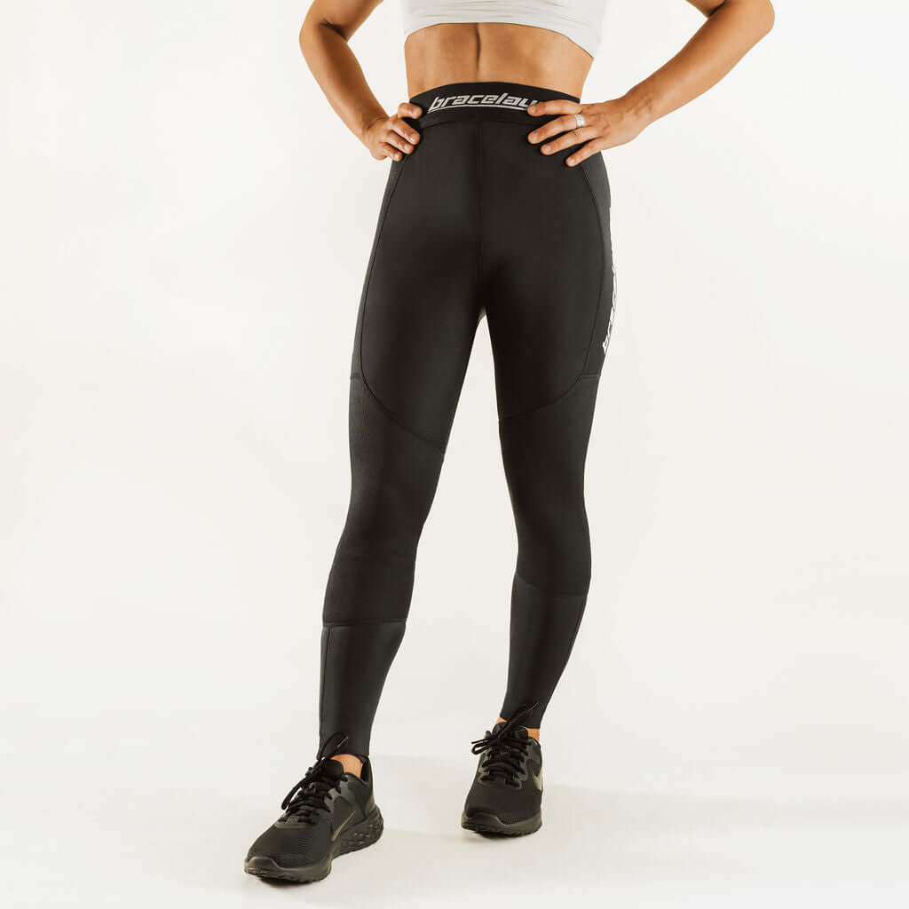 Black thermal base layer leggings with knee support, front view, full-length fit