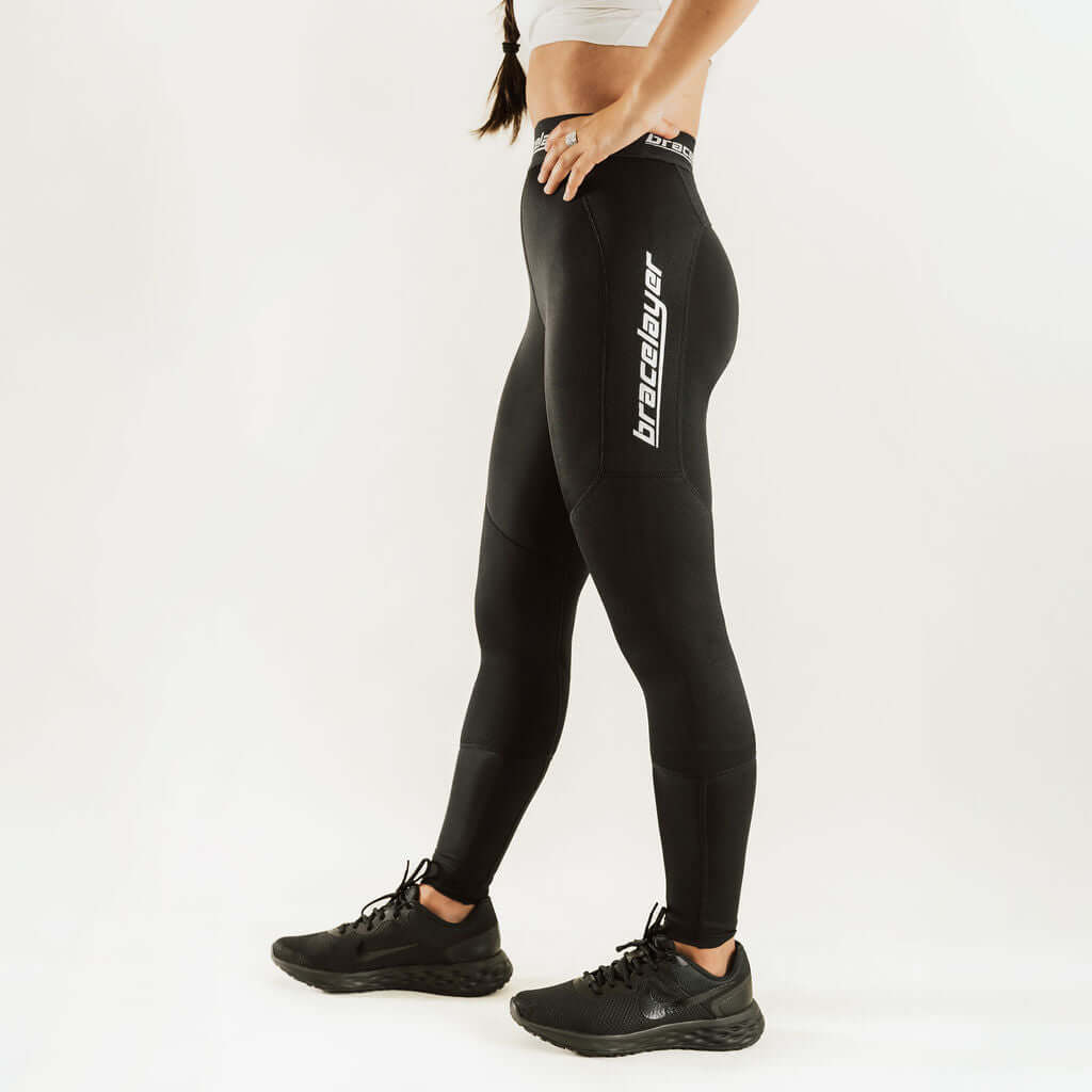 Black thermal base layer leggings with knee support, vertical logo graphic on thigh