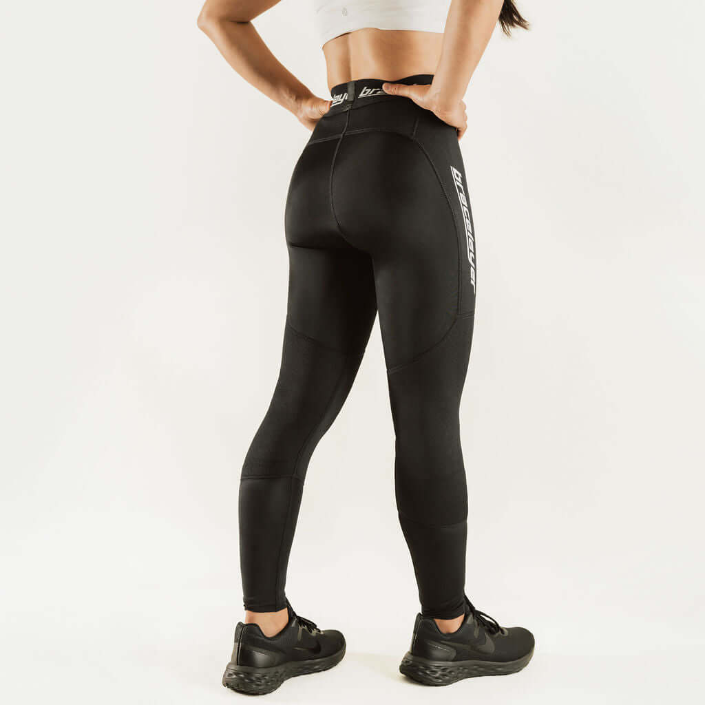 Black thermal base layer leggings with padded knee zones, full-length fit