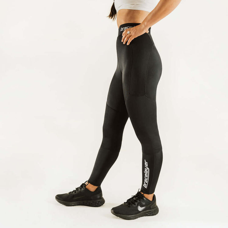 Black compression knee support pants with leg logo stripe and contoured panels.