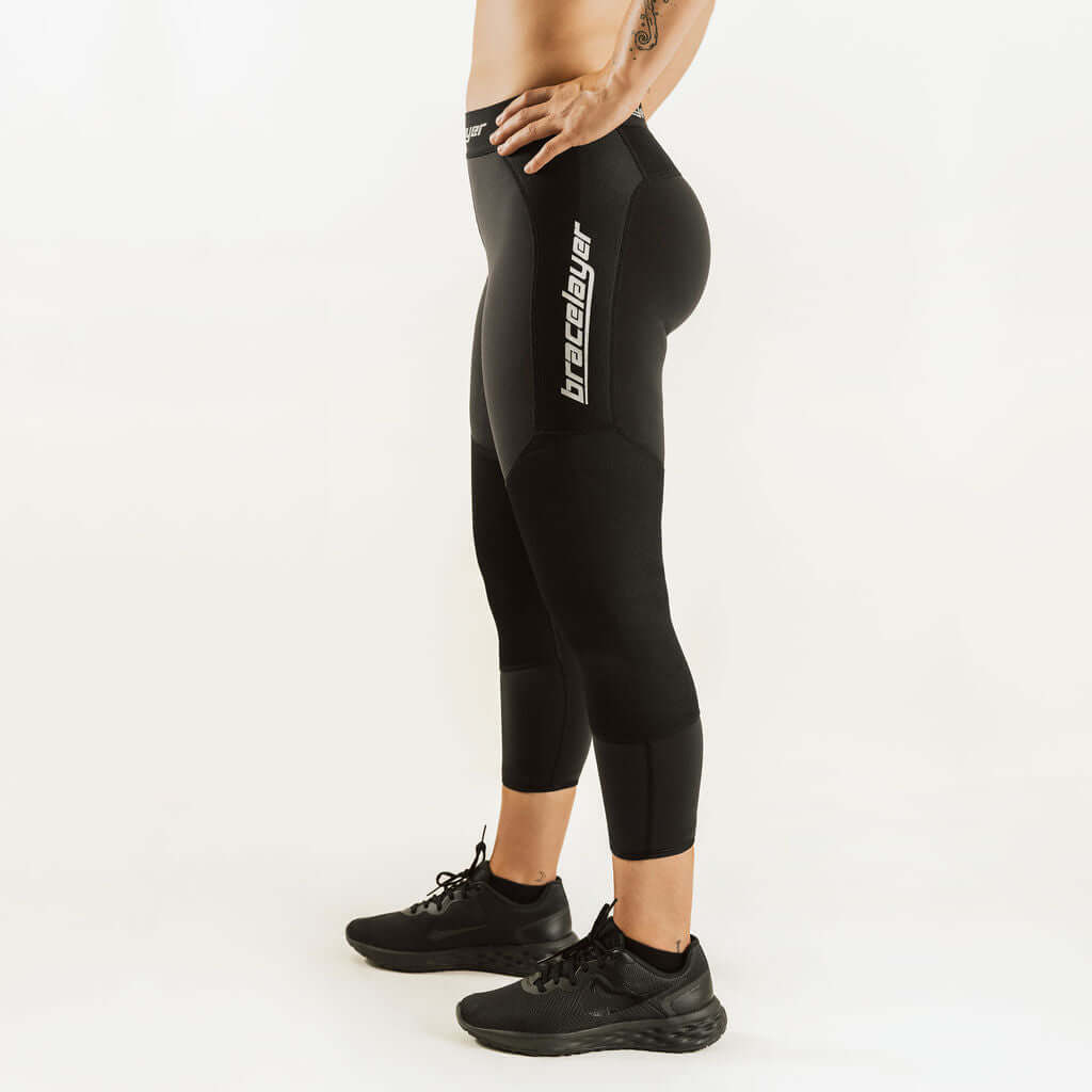 Black 7/8 thermal base layer leggings with vertical logo stripe, women's fit