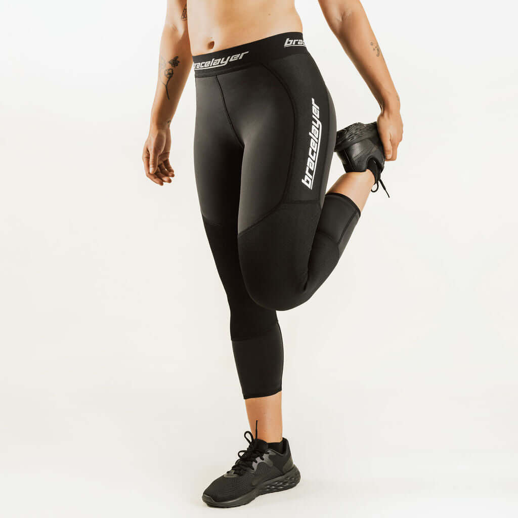 Black 7/8 thermal leggings with side knee-support panel and thigh logo, women's fit