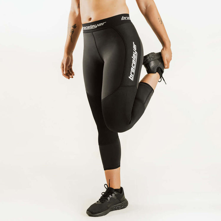 Black 7/8 thermal leggings with side knee-support panel and thigh logo, women's fit