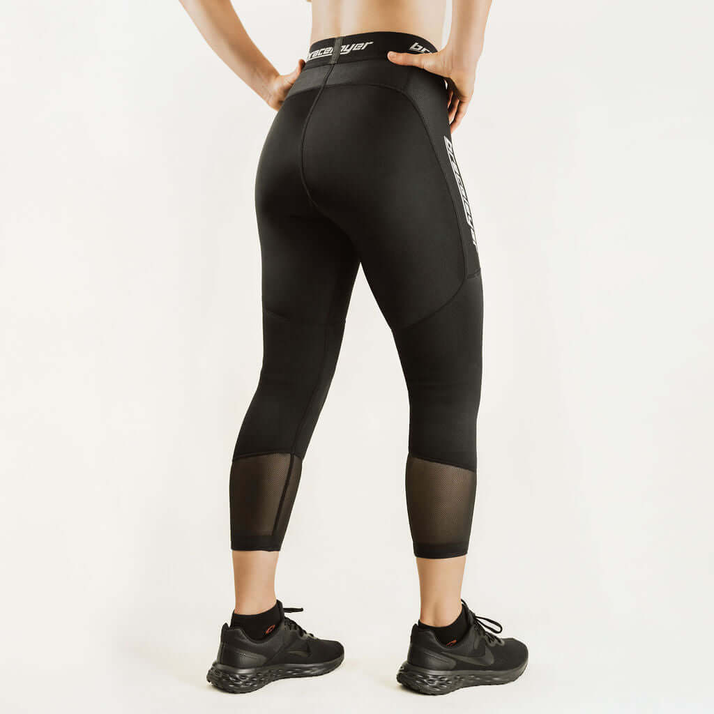 Black 7/8 compression knee support pants, front view with angled knee panel