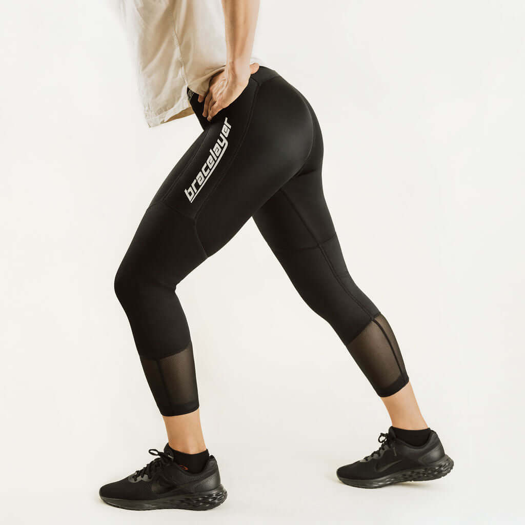 Black 7/8 compression knee support pants, side view with bracelayer knee panel