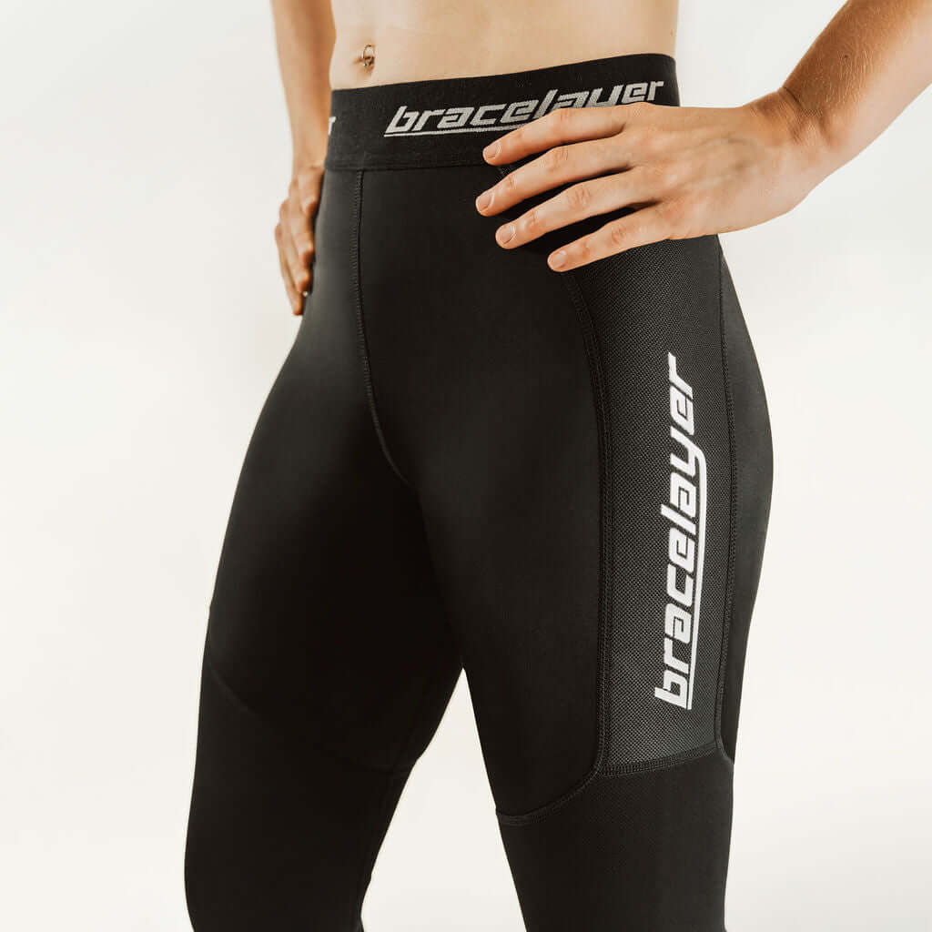 Black 7/8 compression knee support pants with vertical bracelayer leg logo detail